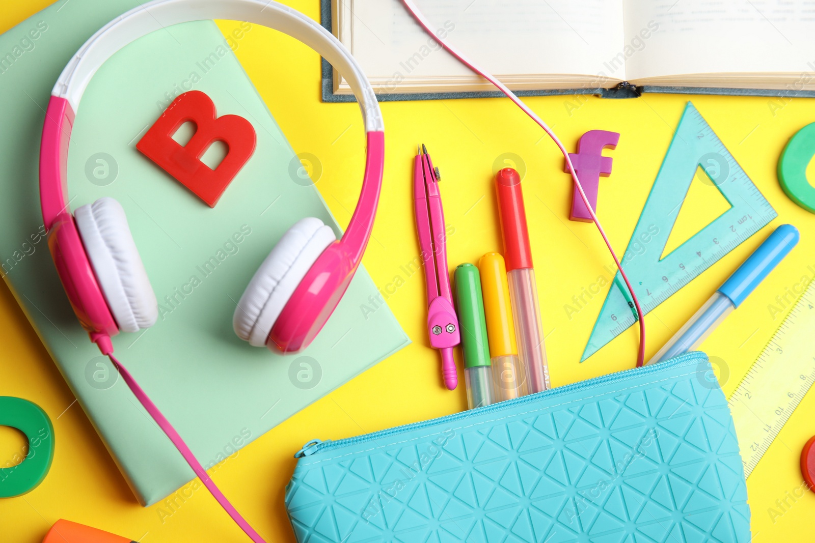 Photo of Flat lay composition with books and stationery on yellow background