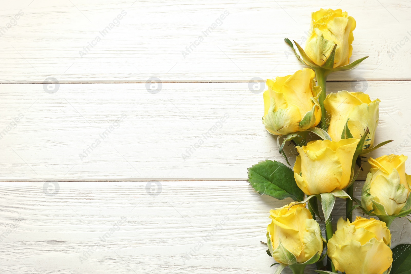 Photo of Flat lay composition with beautiful blooming flowers on wooden background