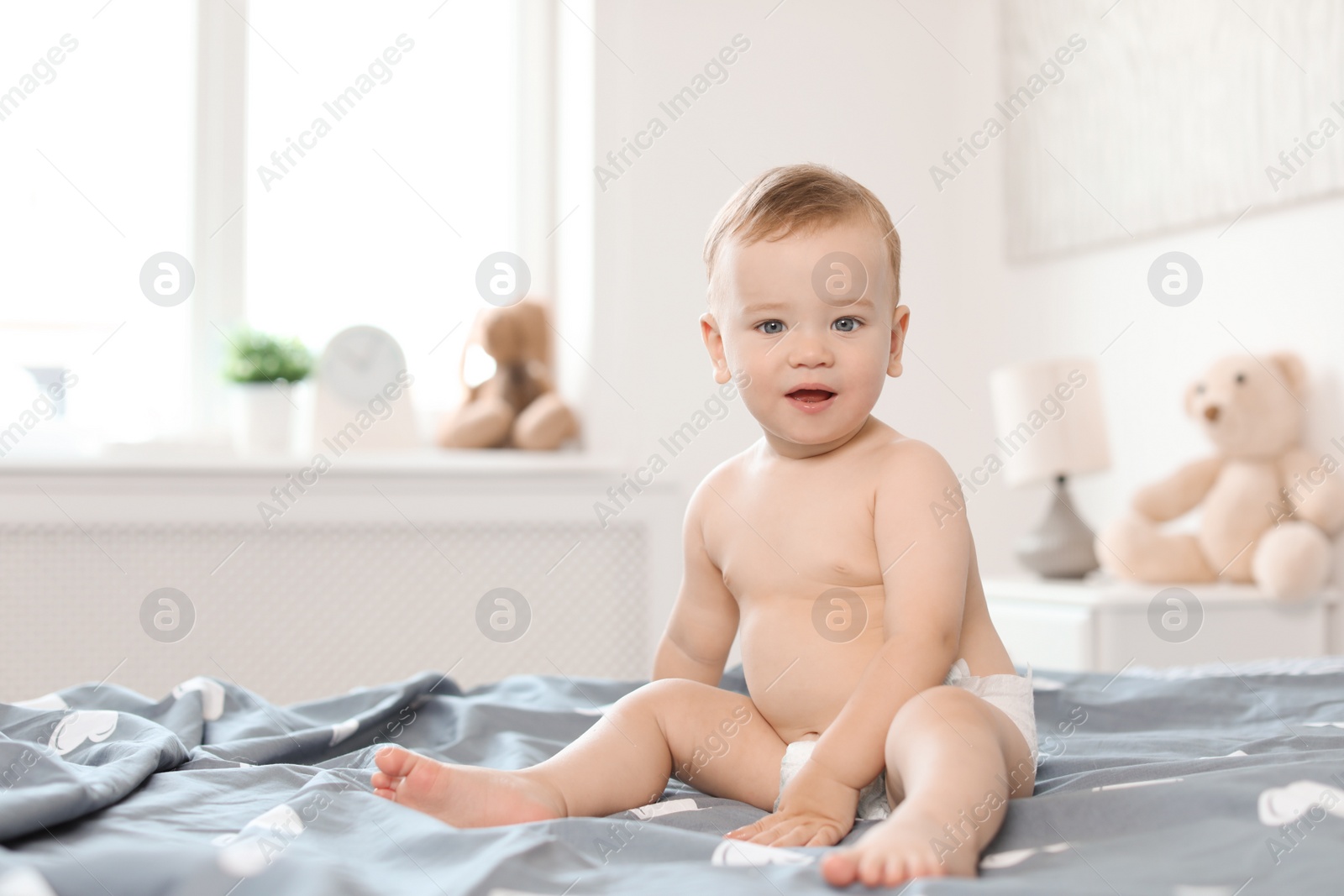 Photo of Adorable little baby on bed at home