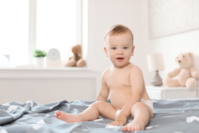 Adorable little baby on bed at home