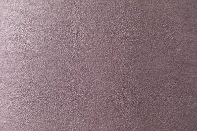 Photo of Texture of coarse sandpaper as background, top view