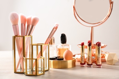 Photo of Set of makeup products and brushes on table