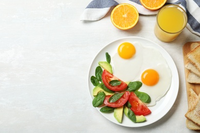 Delicious breakfast with fried eggs served on table, flat lay. Space for text