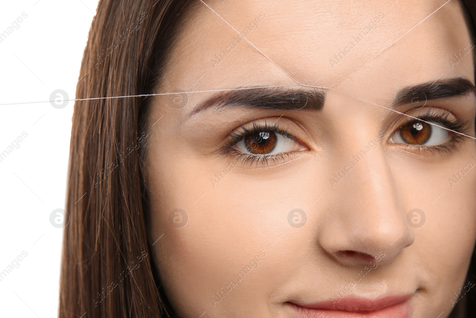 Photo of Young woman having professional eyebrow correction procedure, closeup