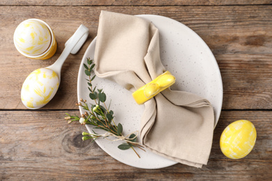 Photo of Rustic Easter table setting with eggs and floral decor, flat lay