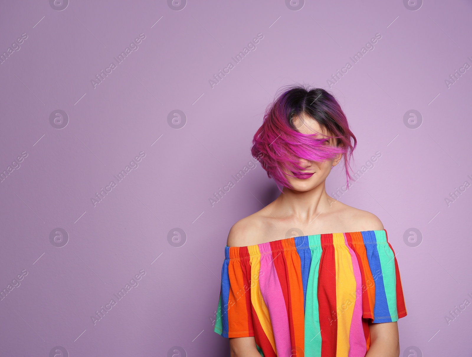 Photo of Young woman with trendy hairstyle against color background