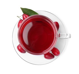 Glass cup of fresh dogwood tea, berries and leaf on white background, top view