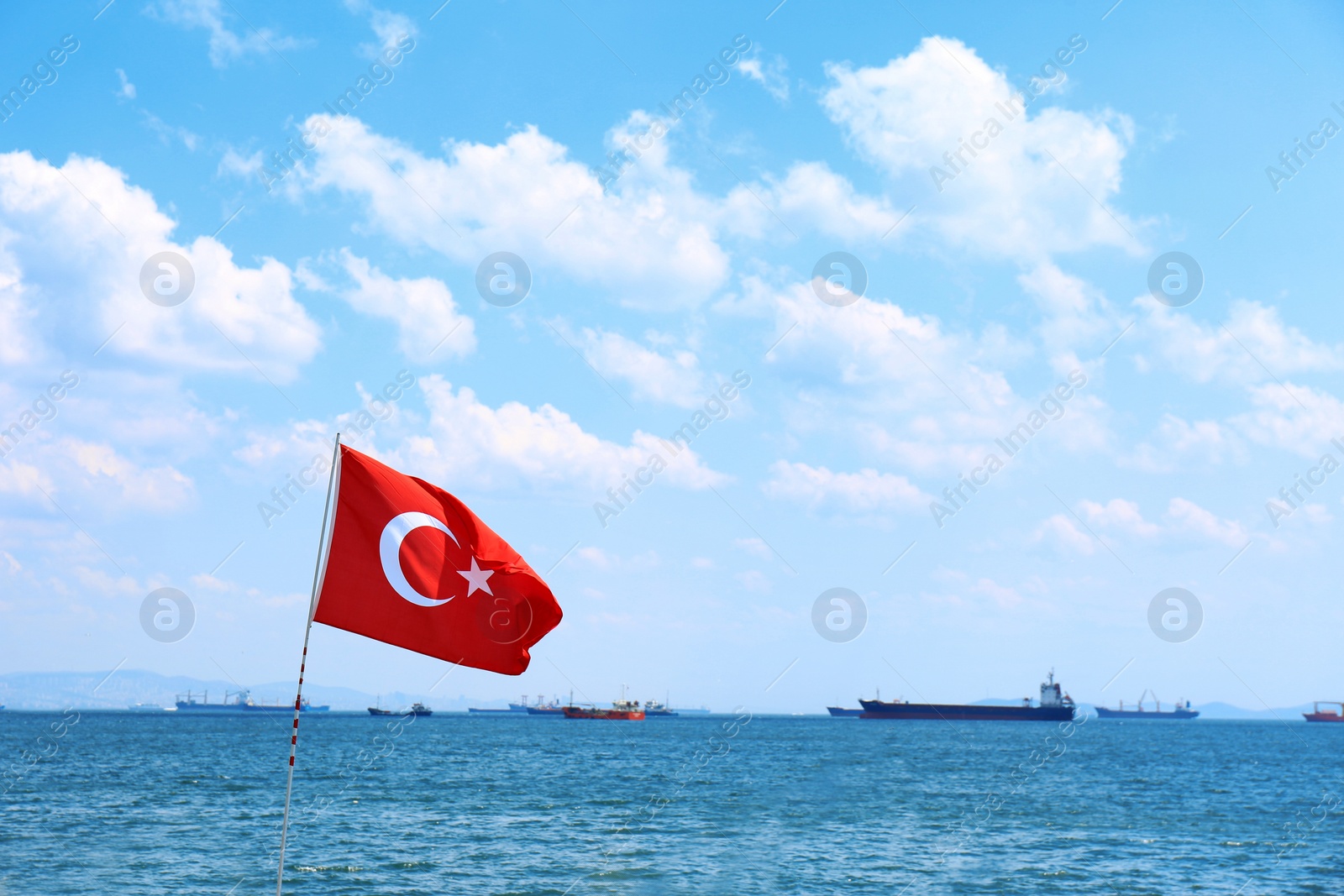 Photo of Turkish flag and seascape with ships on background