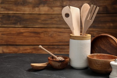 Set of different kitchen utensils on grey table, space for text