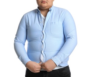 Photo of Overweight man trying to button up tight shirt on white background, closeup