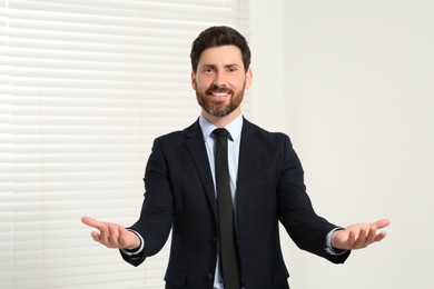 Photo of Handsome real estate agent in nice suit indoors