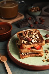 Photo of Tasty toasts with chocolate spread, nuts, strawberries and banana served on wooden table