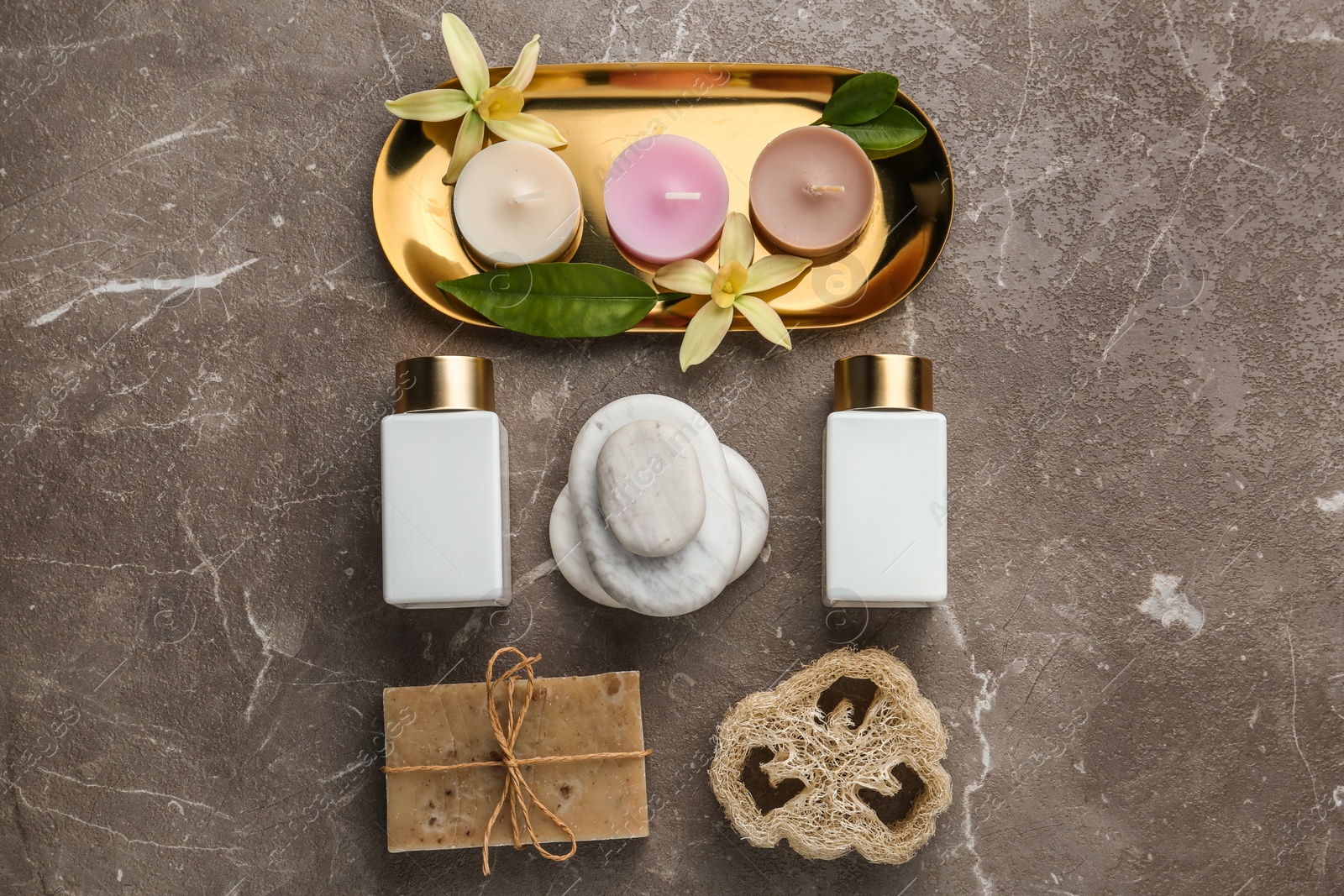 Photo of Flat lay composition with spa supplies on stone table