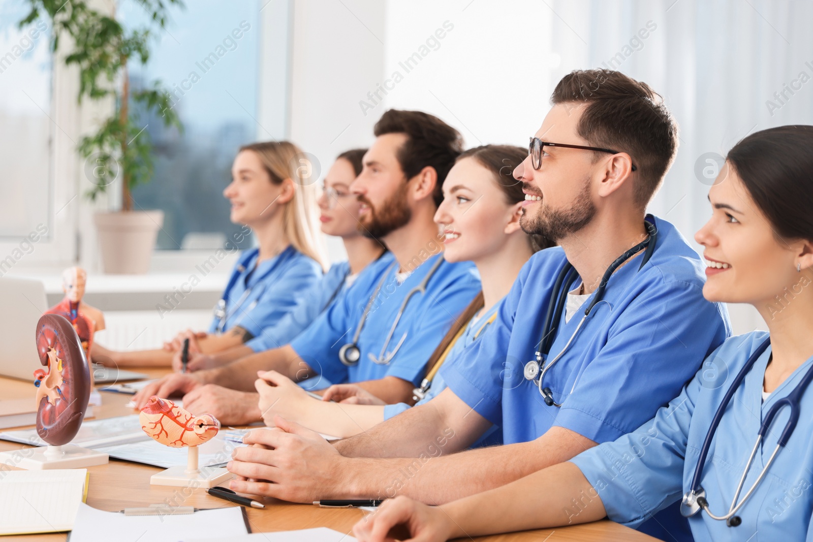 Photo of Medical students in uniforms studying at university