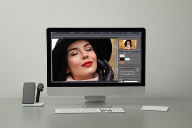 Image of Designer's workplace. Computer with photo editor application on table