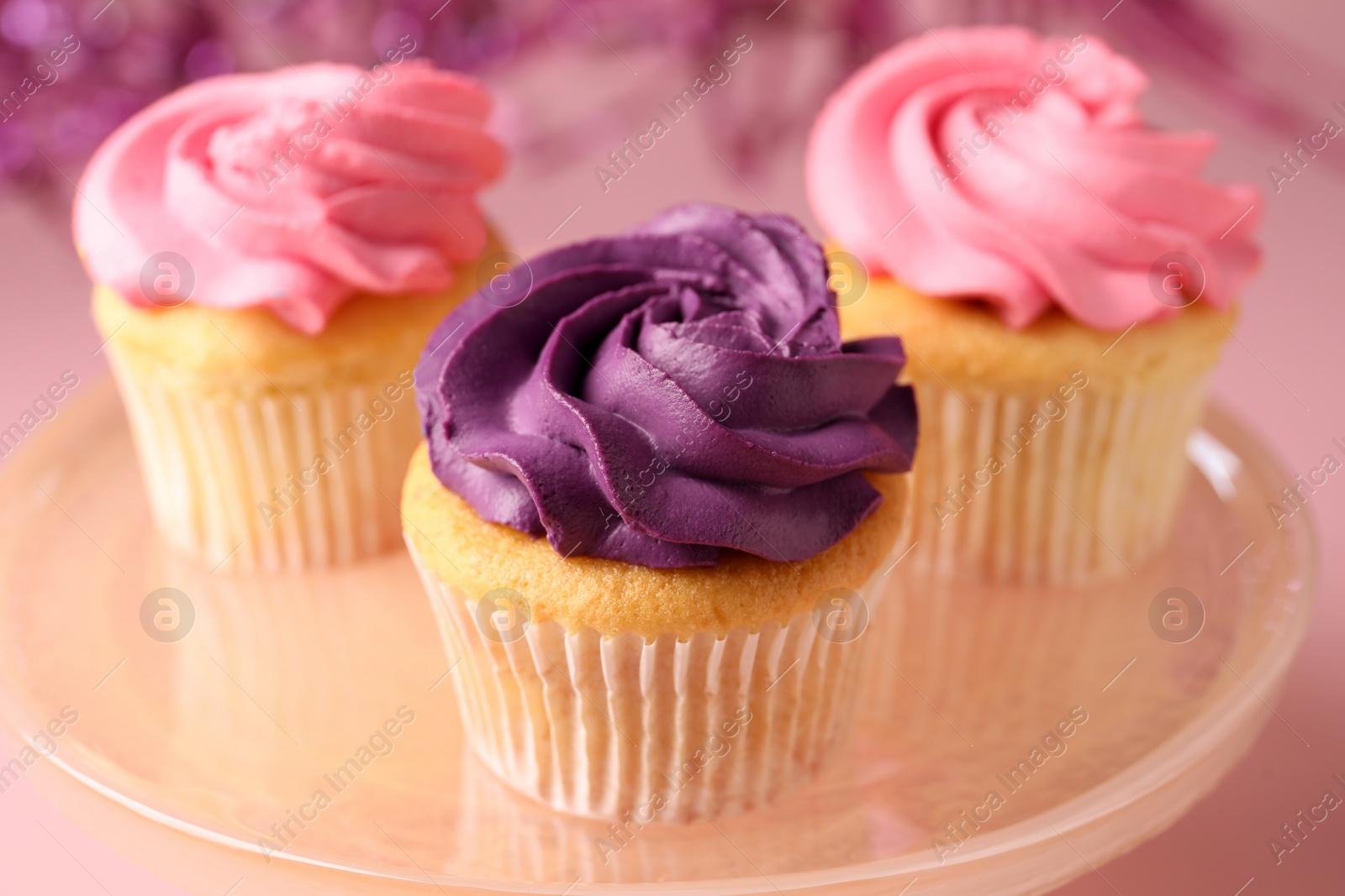 Photo of Delicious cupcakes with bright cream on table, closeup