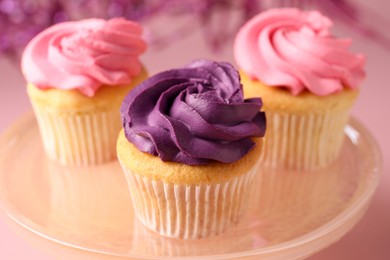 Photo of Delicious cupcakes with bright cream on table, closeup