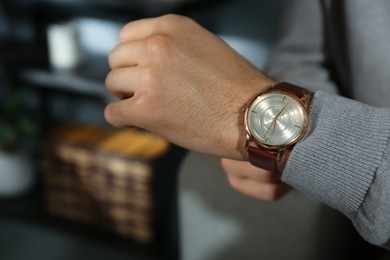 Photo of Man with luxury wrist watch indoors, closeup