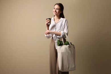Woman with eco bag and takeaway cup on beige background