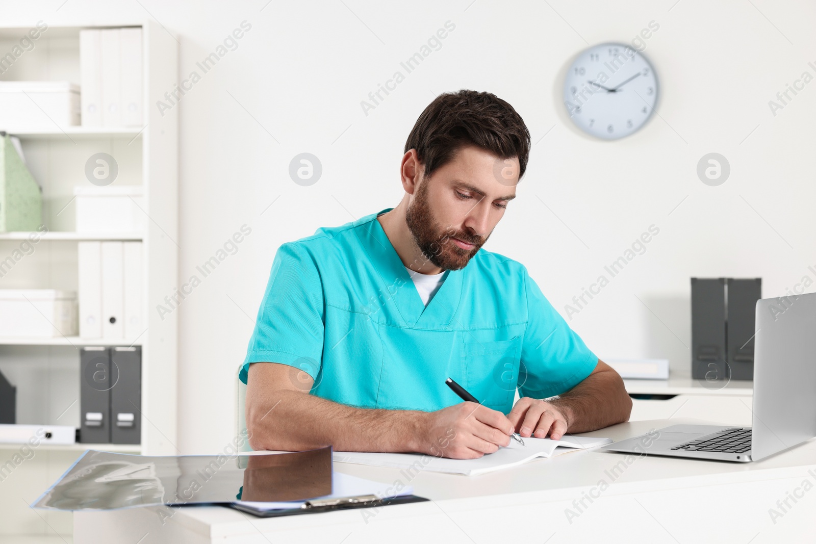 Photo of Doctor writing results from MRI scan in hospital