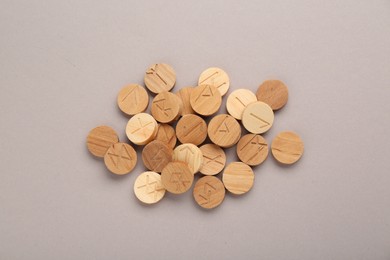 Photo of Pile of wooden runes on light grey background, flat lay
