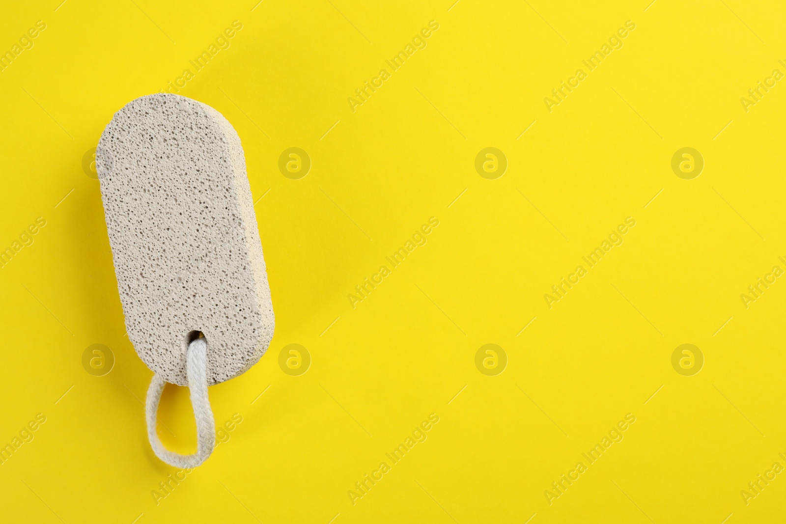 Photo of Pumice stone on color background, top view. Space for text