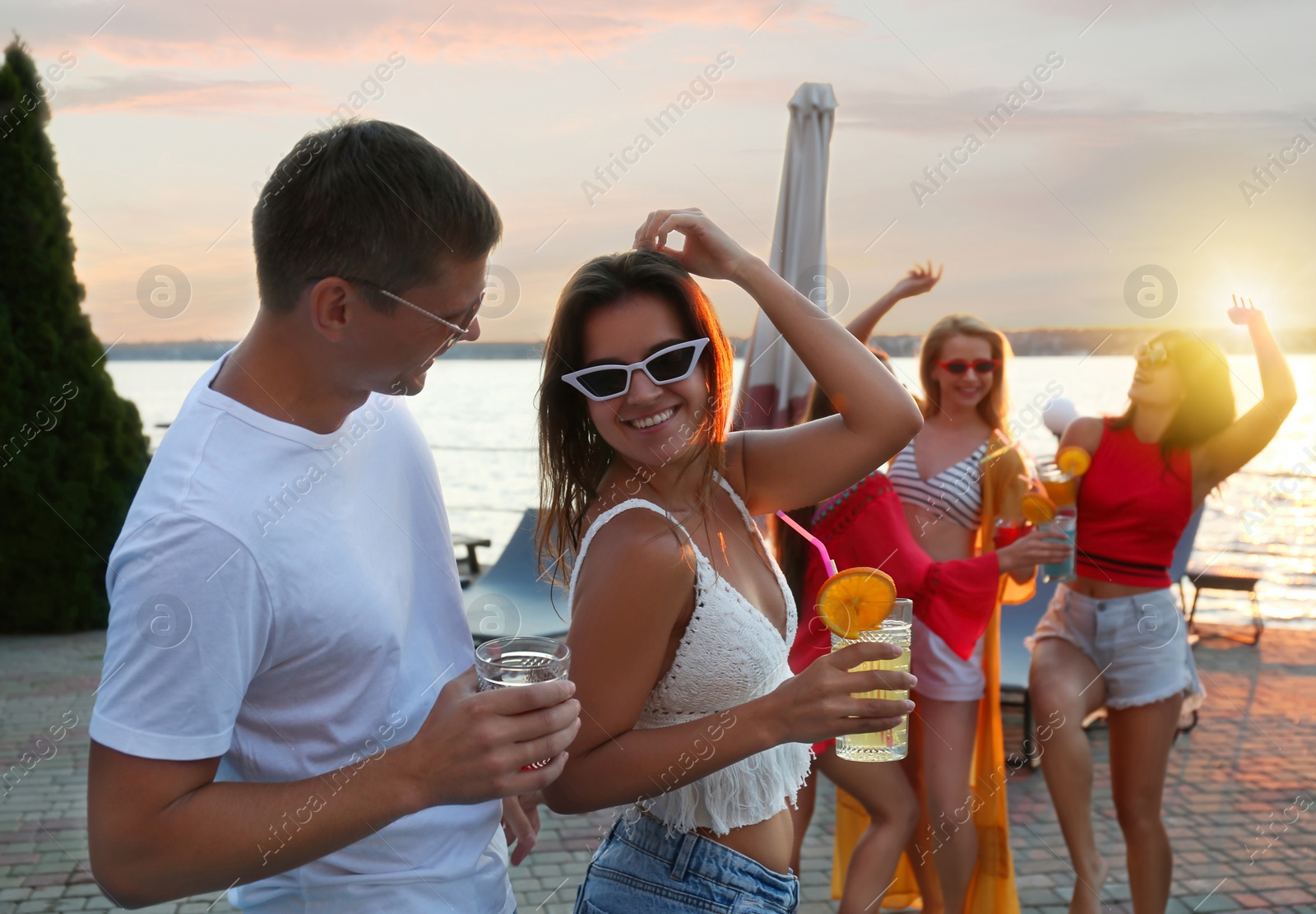 Photo of Group of happy people enjoying fun party outdoors