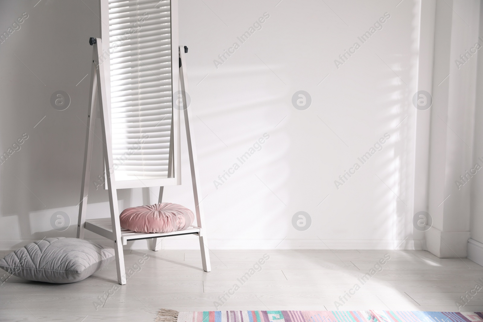 Photo of Large stylish mirror near white wall indoors. Space for text