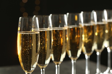 Many glasses of champagne on blurred background, closeup