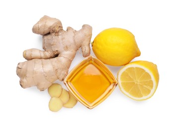 Photo of Natural cough remedies. Bowl with honey, ginger and lemon on white background, top view