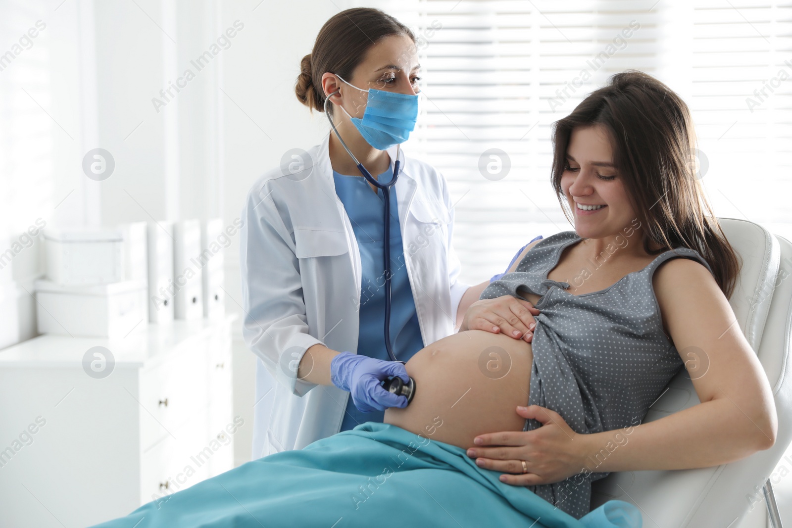 Photo of Doctor examining woman before giving child birth in maternity hospital