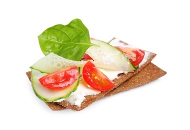 Tasty rye crispbreads with cream cheese, vegetables and basil isolated on white