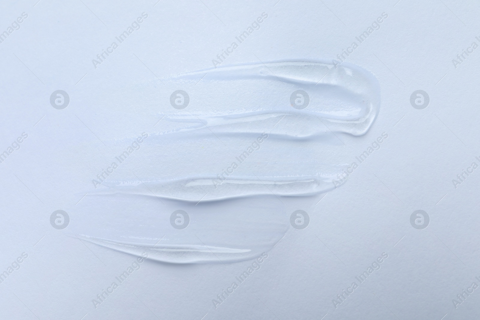 Photo of Swatches of cosmetic gel on white background, top view