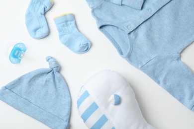 Flat lay composition with baby clothes and accessories on white background