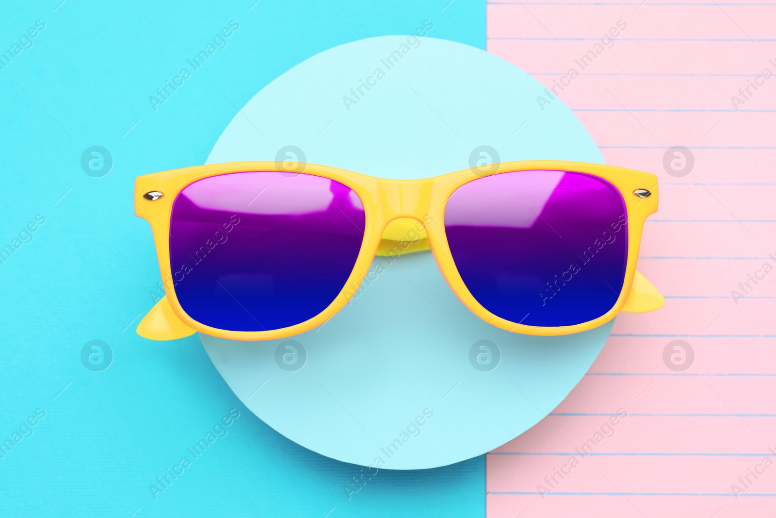 Image of New stylish elegant sunglasses with color lenses on color background