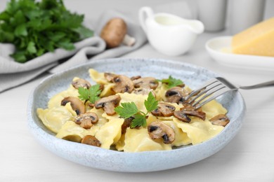 Photo of Delicious ravioli with mushrooms served on white table, closeup