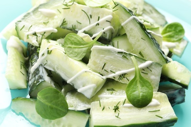 Photo of Delicious cucumber salad with spinach and sour cream on plate, closeup