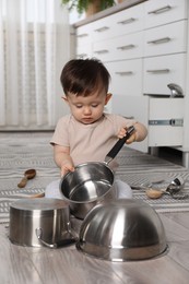 Photo of Cute little boy with cookware at home