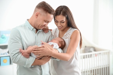 Happy couple with their newborn baby at home