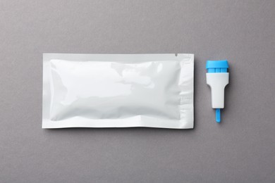 Disposable express test kit on gray background, flat lay