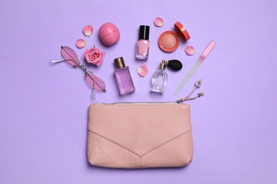 Photo of Flat lay composition with sunglasses and perfumes on violet background