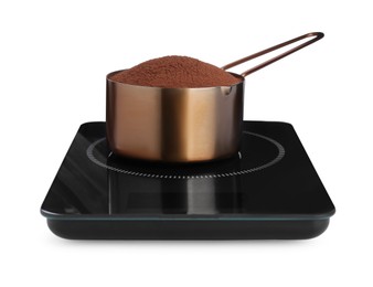 Modern kitchen scale with saucepan of cocoa powder isolated on white