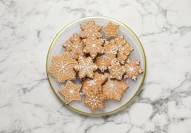 Photo of Tasty Christmas cookies on white marble table, top view