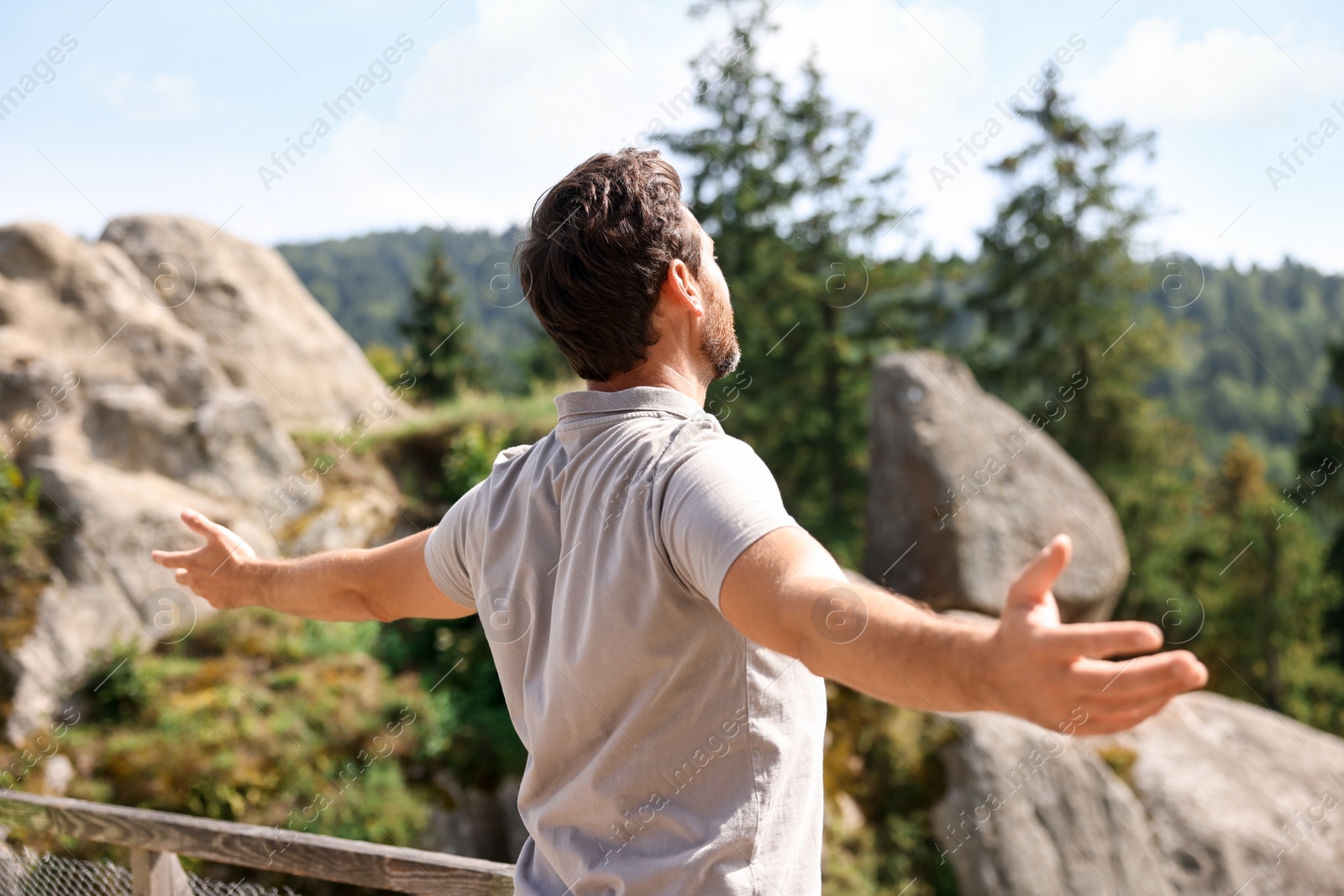 Photo of Feeling freedom. Man with wide open arms in mountains