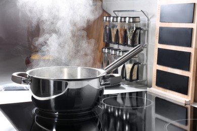 Steaming pot on electric stove in kitchen