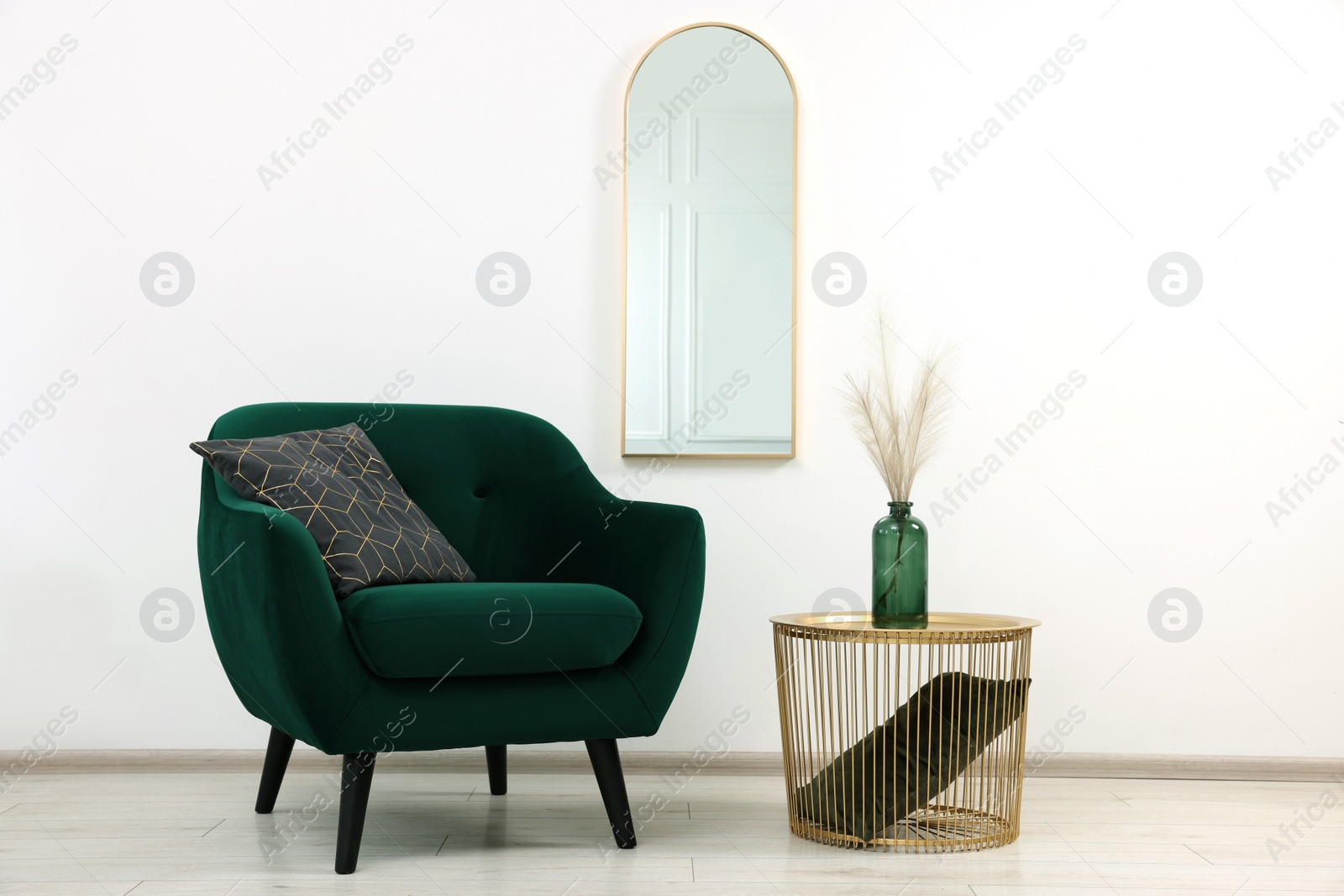 Photo of Stylish room interior with comfortable armchair and side table