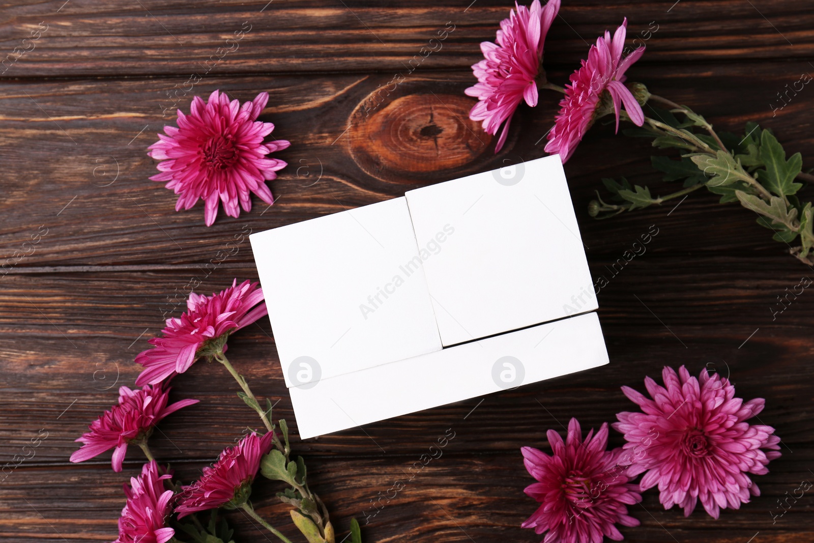 Photo of Thanksgiving day, holiday celebrated every fourth Thursday in November. Block calendar and beautiful chrysanthemums on wooden table, flat lay