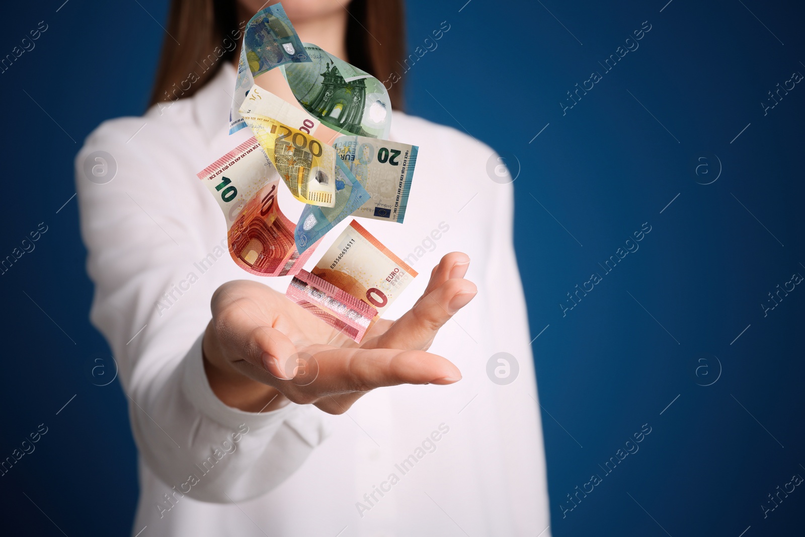 Image of Woman with money on blue background, closeup. Currency exchange