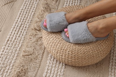 Photo of Woman wearing grey soft slippers indoors, closeup