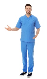 Photo of Full length portrait of smiling male doctor in scrubs isolated on white. Medical staff